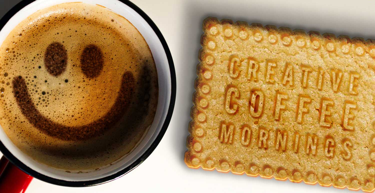 Creative coffee mornings – a smiley in chocolate on a cappuccino and a biscuit